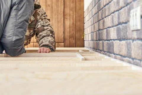 Workers assembles a plywood frame for a kitchen countertop Stock Photos