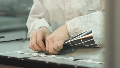 Workers assembling the back cover of a household TV on a factory assembly line Stock-Footage 162366855
