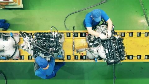 Workers assembling car engines at an industrial factory. Stock Footage 142226755