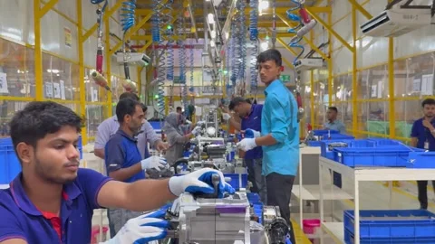 Workers assembling engines on production line in Indian factory Video stock 344099308