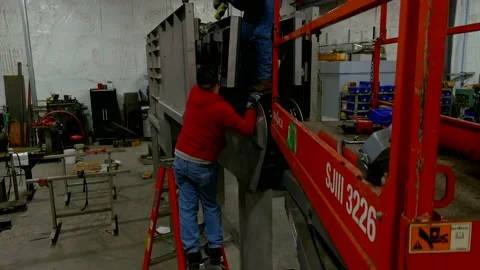 Workers assembling machine Stock Footage 201265968