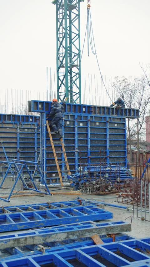 Workers Assembling Reinforced Concrete Formwork Stock Footage 296756149