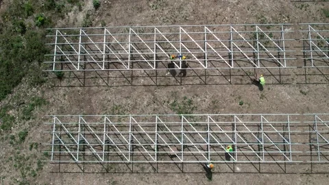 Workers assembling solar panel mounting frames, aerial view Stockbeeldmateriaal 278367901