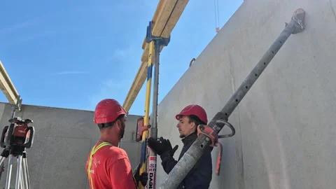 Workers Assembling Timber Beam Formwork with Laser Level Stock-Footage 334128924