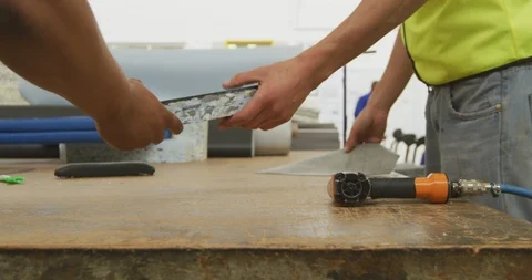 Workers assembling two objects Stock Footage 124591486