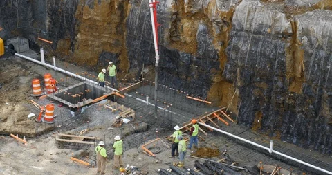 Workers assisting in pouring concrete Stock Footage 88650499