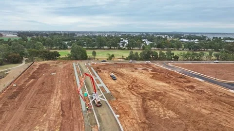 Workers beside concrete pumper move fresh concrete around in new footpath Stock Footage 278301031