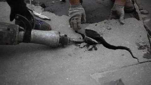 Workers break the asphalt with a jackhammer. Stock Footage 136166901