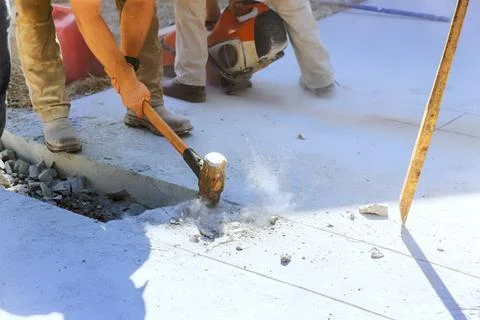 Workers break concrete in construction site using tools for repair renovation Stock Photos
