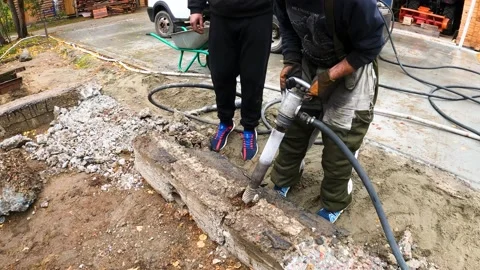 Workers break concrete with pneumatic jackhammers Stock Footage 195979971