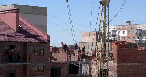 Workers Bricklaying House With Tower Crane Equipment Stock Footage 62505209