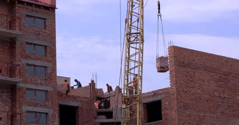 Workers Bricklaying House With Tower Crane Equipment Stock Footage 64173000