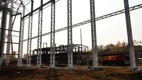 Workers' brigade at the construction site stands under the metal structures Stock Footage 74005310