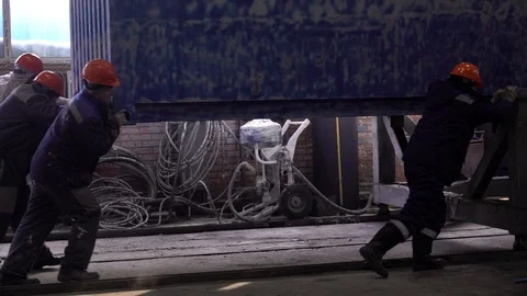 Workers bring the container into the box for painting. Stock Footage 105228360