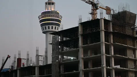 Workers build highrise near Samut Prakan observation tower Video stock 339875425