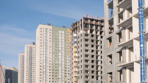 Workers build house mounting panel against buildings Stock Footage 124299310