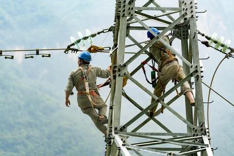 Workers build power line on cliff in Zigui, central China's Hubei Stock Photos