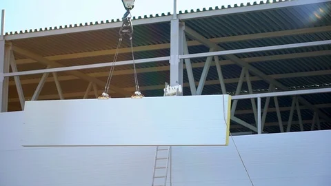 Workers, builders on the construction site. Installation sandwich panels Stock Footage 98322232