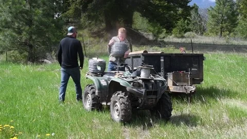 Workers building fence loading barb wired on ATV, 4x4, Stock Footage 222808587