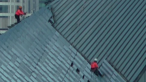  Workers on a building, high up in the city. Stock Footage 86583684
