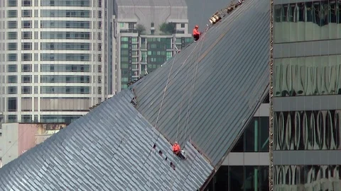  Workers on a building, high up in the city. Stock Footage 86584038