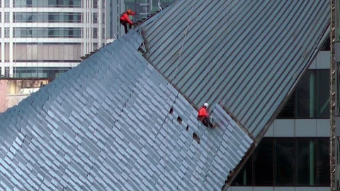  Workers on a building, high up in the city. Stock Footage 86585357