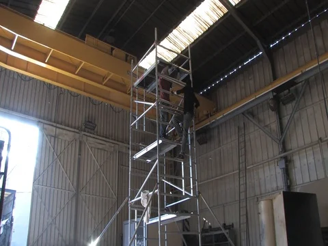 Workers building a tower in wharehouse Stock Footage 71245902
