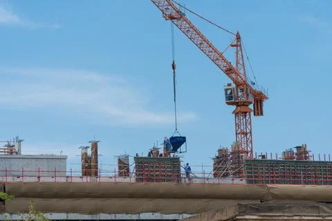 Workers busy at a construction site Stock Photos