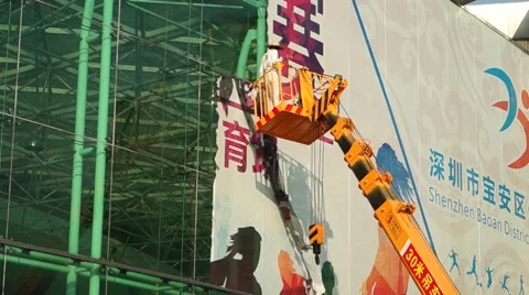 Workers in the cable car on high altitude demolition advertising signs Stock Footage 46130862