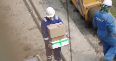 Workers carry cargo in boxes and trays with steady rhythm Vídeos de archivo 319831941