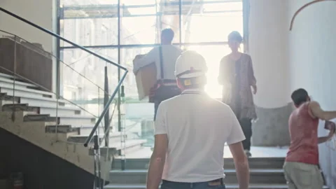 Workers carry construction materials and supplies in office 库存影片 243811978