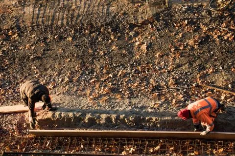 Workers carry out construction work on laying the sidewalk . Stock Photos