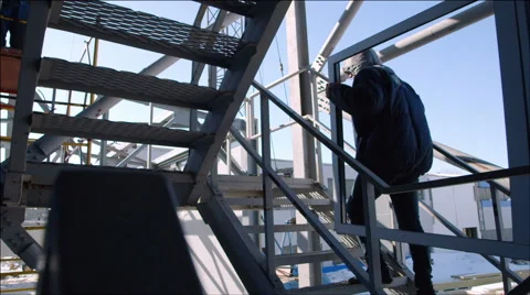 Workers carry the window frame up the stairs - Hard men's work Stock Footage 40541221