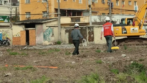 Workers carrying construction equipment Stock Footage 77048252