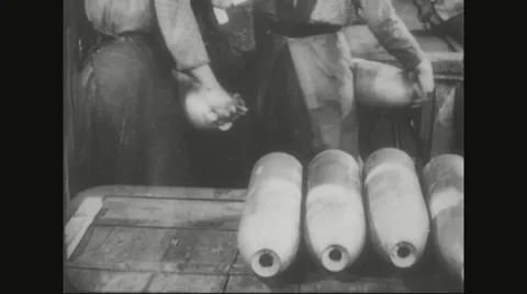 Workers carrying sealed iron from trolley and placing it on table Stock Footage
