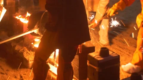 Workers Casting a Liquid Metal Into the Molds Bright Orange Metal Shining in Stock Footage 64359521
