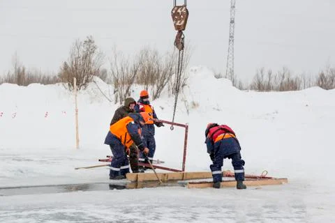 Workers catch ice blocks in the lane 스톡 사진