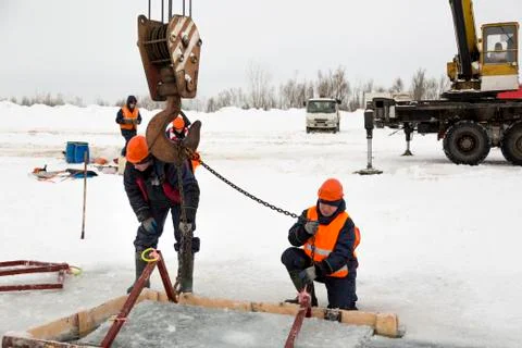 Workers catch ice blocks in the lane 스톡 사진