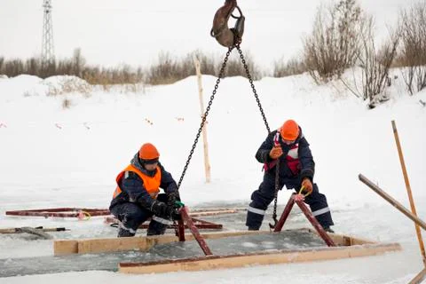 Workers catch ice blocks in the lane 写真素材