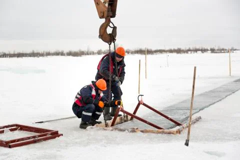 Workers catch ice blocks in the lane 写真素材