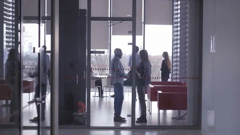 Workers chatting with each other while taking a break at the office Stock Footage 73870631