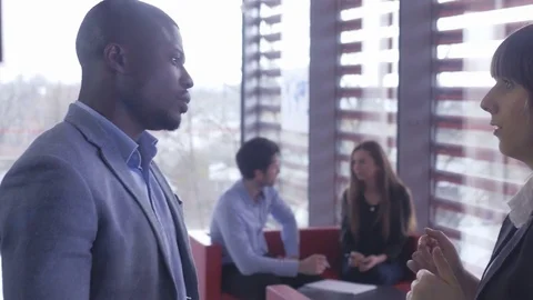 Workers chatting with each other while taking a break at the office Stock Footage 74284613