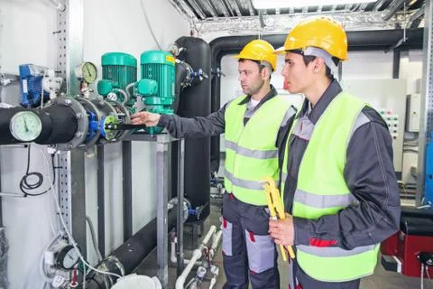 Workers check pipe monometer Stock Photos