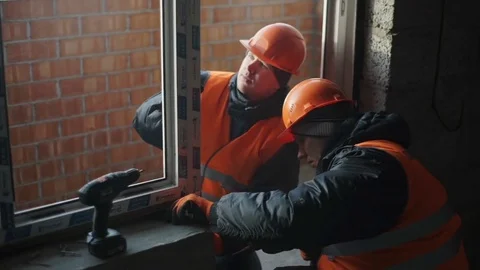 Workers check the window frame on to irregularities Stock Footage 82294724