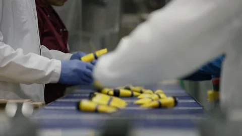 Workers checking and packing cosmetics in boxes in factory Stock Footage 107993366