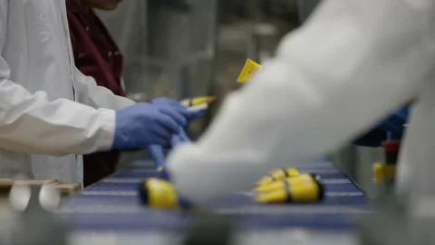 Workers checking and packing cosmetics in boxes in factory Stock Footage 107993389