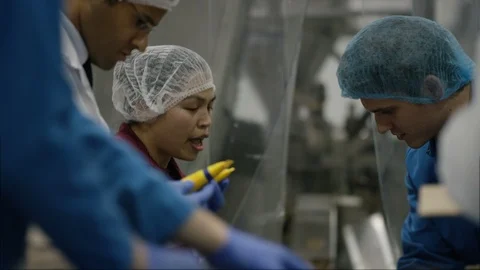 Workers checking cosmetics before packingm in boxes in factory Stock Footage 107992787