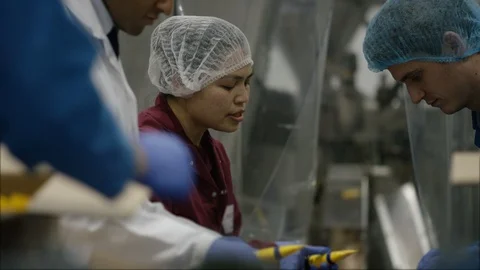 Workers checking cosmetics before packingm in boxes in factory Stock Footage 107992963