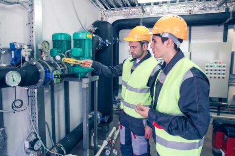 Workers checking parameters of pressure Stock Photos