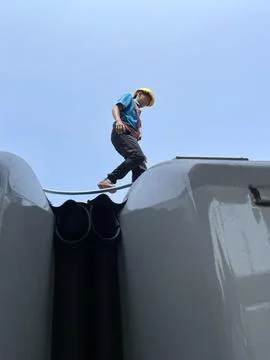 Workers at Cirebon Station, West Java, on the roof of a train Stock Photos